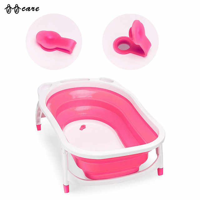 Pink and white folding bathtub with two pink handles on a white background