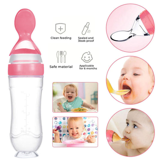 Pink baby feeding bottle with spoon attachment on a white background